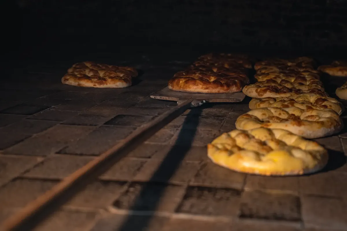 Golden brown loaves in a traditional stone oven, capturing the essence of artisanal bread making.