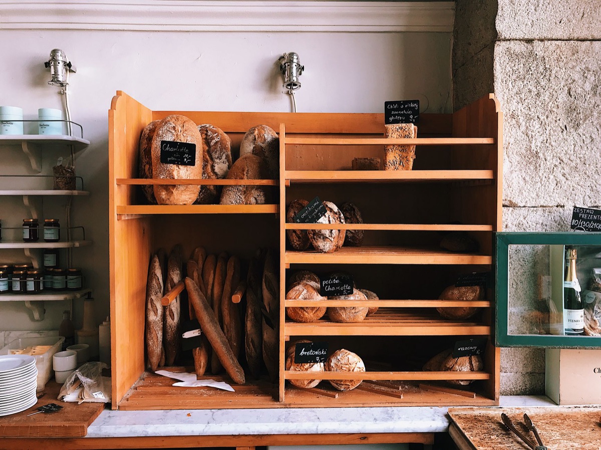 Wooden bakery counter with artisanal baguettes and flour dust
