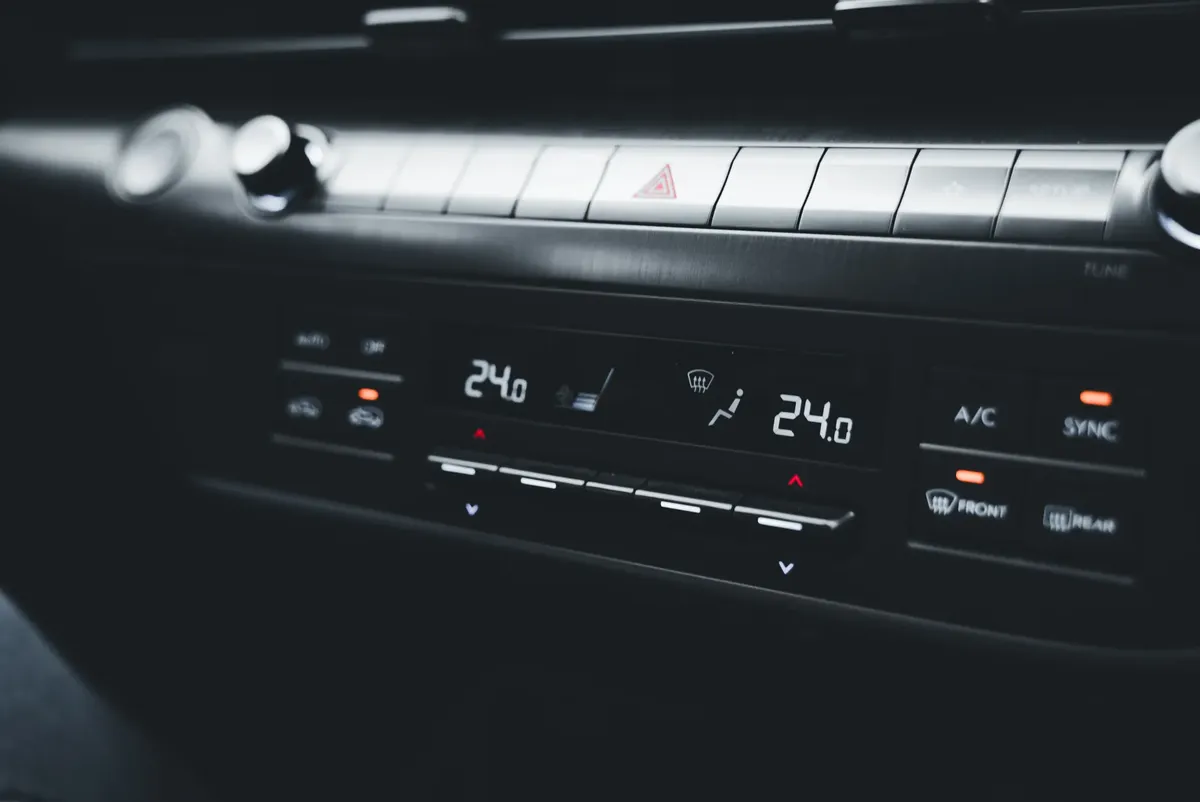 Close-up shot of a car's climate control system displaying temperature settings.
